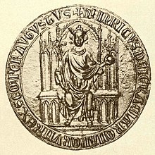 Kruhová zlatá pečeť, jež vyobrazuje muže v rouchu s korunou a královským žezlem a jablkem sedícího na trůně.