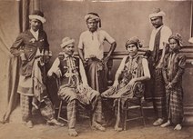 Heads of Aceh at Singapore. Standing at the left: Teukoe Kali. Standing, 2nd from the right: Moekims. Sitting at the left: Panglima dalem. Sitting at the right: Strabander of Atjeh KITLV - 155858 - Heads of Aceh at Singapore - circa 1870.tif