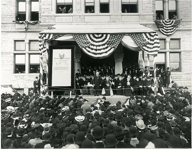 The Knights of Columbus presented a check to Catholic University of America on the steps of the university's McMahon Hall in 1904 to establish a Chair