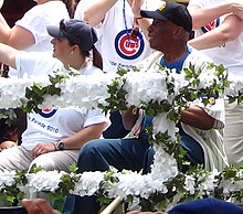 Ricketts representing the Cubs organization at the 2010 Chicago Pride Parade, accompanied by former Cubs player Ernie Banks Laura Ricketts and Ernie Banks (4741788452).jpg