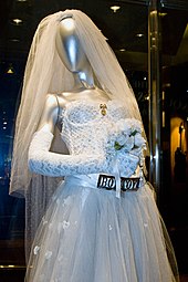 A wedding dress displayed on a mannequin.