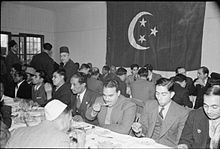 Muslims during an Eid al-Fitr feast at the East London Mosque in 1941 Muslims in Britain- Eid Ul Fitr Celebrations, 1941 D5142.jpg