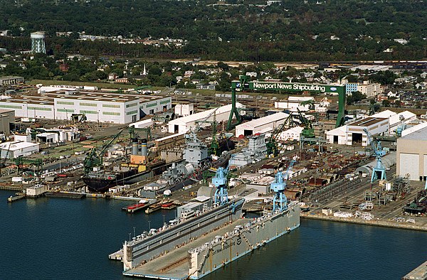Aerial view of the Newport News shipyard in 1994. Visible in the drydocks are USS Long Beach and USNS Gilliland