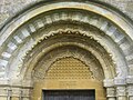 A Norman arch above the church doorway at Guiting Power