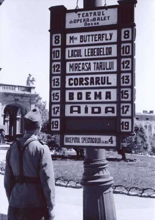 Romanian soldier reading an opera house advert in Odesa, 1942. The photo also demonstrates the spelling of Odesa in 1942.