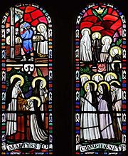 Church stained-glass window depicting the martyrdom of a line of nuns