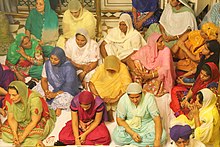 Female pilgrims inside the Harmandir Sahib Pilgrims inside the Hari Mandir Sahib (Darbar Sahib) - Golden Temple (9693313454).jpg