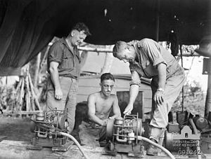 Simpson (right), inspects Chorehorse chargers at 3 Division Signals during his visit to Bougainville in April 1945.