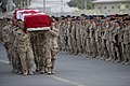 A Canadian honor guard carries the remains of Pte. Sebastien Courcy during a sundown ramp ceremony at Kandahar Air Field, Afghanistan on July 17, 2009.