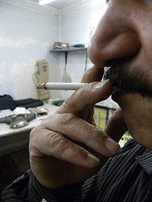 An Iranian man smoking interior Tailor man Smoking 1.jpg