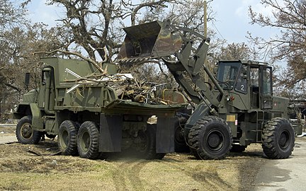 M939 series 5-ton 6x6 truck 432px-US_Navy_050904-N-6204K-028_A_U.S._Navy_Seabee_bulldozer_dumps_Hurricane_Katrina_debris_into_a_dump_truck_during_clean-up_efforts_in_Biloxi%2C_Miss