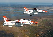 Two T-45Cs from VT-9 US Navy 061118-M-3924S-006 Two T-45C Goshawk jets from Training Air Wing One (TW-1) prepare to perform flyover maneuvers for football fans at Gator Stadium.jpg