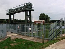 The sluice which controls flow from the River Wissey into the cut-off channel, with a pumping station in the background