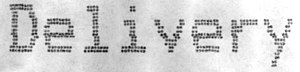 The word "Delivery" as output in a bold, large font by a dot matrix receipt printer, as seen under a low-powered microscope