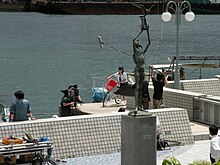 Cameras and crew surround a young woman being filmed for the TV show