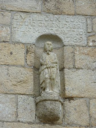 Statue et inscription sur le portail de l'église paroissiale.