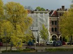 A photo of Autumn in Amsterdam city, free download; colored elm trees in Spring with yellowing flower leaves and brick building facades. Fons Heijnsbroek, street photography of The Netherlands in high resolution; free image CC0