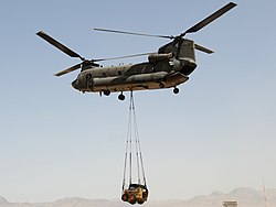 An Australian army CH-47 Chinook Helicopter lifts a front loader off the flight line at Special Operations Task Force-Southeast's Forward Operating Base Camp Ripley, Tarin Kowt.jpg