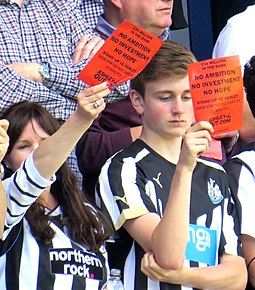 Newcastle fans show "Mike Ashley Out" cards away to QPR, May 2015 AshleyOut2015.JPG
