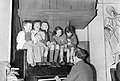 At a Save the Children club on Eversholt Street, London, during 1944, children sit on the piano being played by one of the club warden's. D19255.jpg