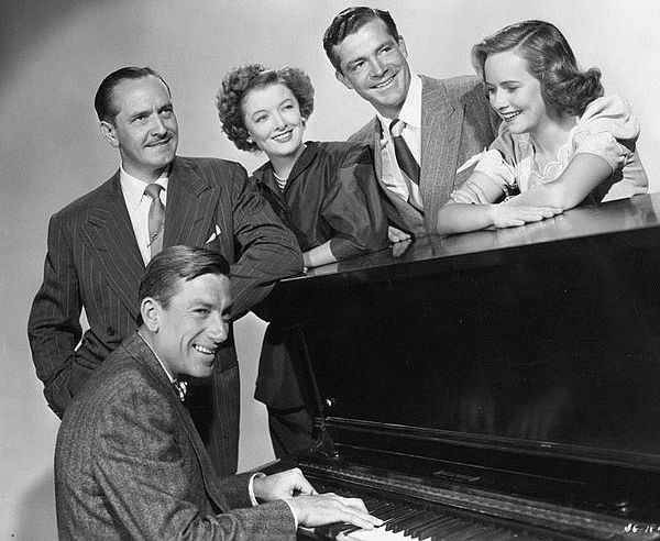 Standing (left to right): Fredric March, Myrna Loy, Dana Andrews, Teresa Wright; seated at piano: Hoagy Carmichael