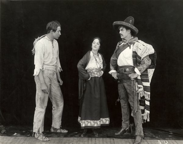 Film still (left to right) of Monte Blue, Cooper, and Hobart Bosworth in costume for Betrayed (1917)