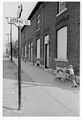 Child pushing a stroller down the street near Lebreton Flats.jpg