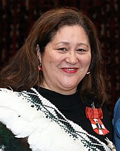 A smiling woman wearing the badge of the New Zealand Order of Merit