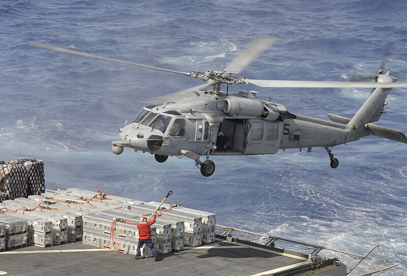 File:Crew member attaches cargo to a Sea Hawk at sea. (8692079213).jpg