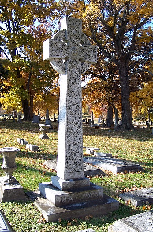 A Celtic cross stands in the center of the Dallas family burial lot.