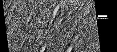 Wide-view of layers, as seen by HiRISE under HiWish program. Box shows location of next image. Dark parts of image are dark, basalt sand sitting on level places.