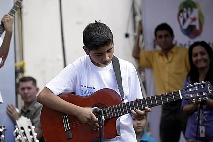 Salvadoran boy playing the guitar