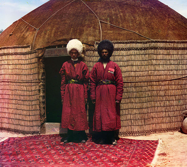 Two Turkmen men standing on a carpet in front of a yurt. Photo by Prokudin-Gorsky between 1905 and 1915