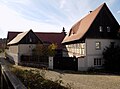 Residential stable house, side building and barn of a three-sided courtyard as well as enclosure wall and gate system