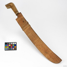 A Tangkin inside a wooden sheath. Iban 'working' parang WEA 2064 (01).png