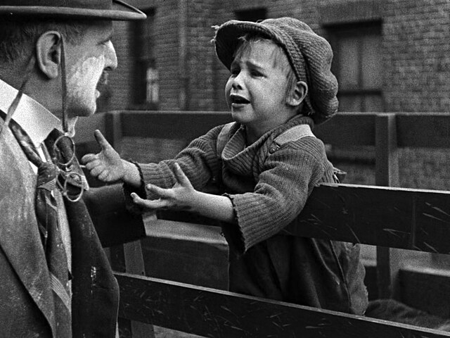 "The Kid" pleading to be left with his "father", Chaplin