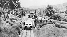 A motorized railcar leaving Buff Bay station, in 1960 Jamaican railroad with railcar and station 1960.jpg