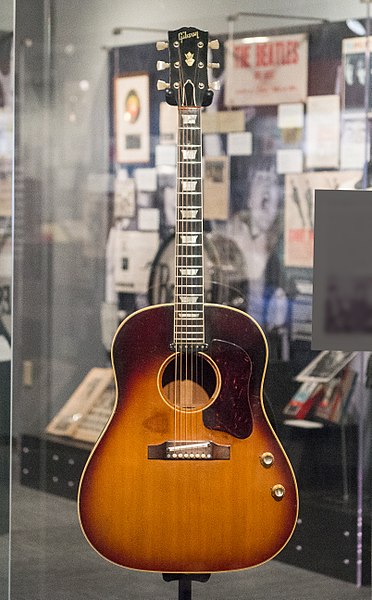 File:John Lennon's missing 1962 Gibson J-160E guitar in the exhibit (clip3) - Ladies and Gentlemen... the Beatles! exhibit at LBJ Presidential Library, Austin, TX, 2015-06-12 11.37.55.jpg