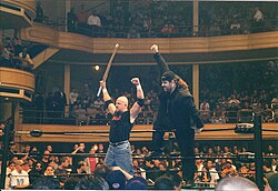 D'Angeli (right) as Lou E. Dangerously with Justin Credible in 2000 Justin Credible and Sign Guy Dudley Posing.jpg