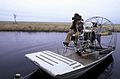 Man driving airboat on swamp water.jpg