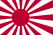 A flag bearing a stylised red sunburst symbol on a white background.