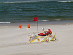 A lifeguard on duty at a beach natural=beach lifeguard=yes