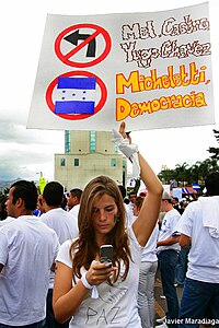 Honduran demonstrator holding a banner with a "don't turn left" sign, 2009. Pro-Micheletti demonstrators.jpg
