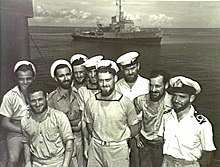 Australian sailors with a Bathurst-class corvette in the background. The RAN commissioned 56 of this class of corvettes during World War II. RAN Sailors (AWM P00001-418).jpg