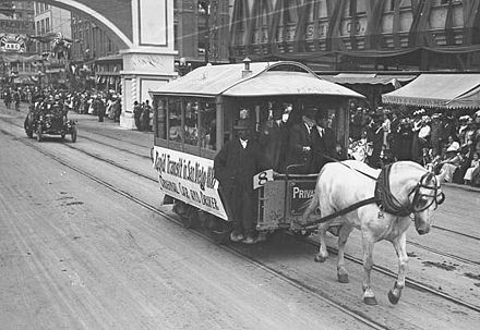 An original 1886 horse-drawn trolley in a parade celebrating the groundbreaking of the Panama–California Exposition Center in 1911.