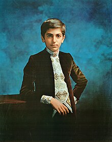 Iranian prince Reza Pahlavi wearing Peacock Revolution-inspired velvet Nehru jacket and geometric print scarf, 1973. Reza Pahlavi Crown Prince of Iran 1973.jpg