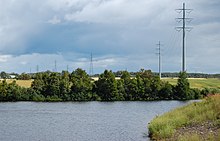 The Chicoutimi River crossing agricultural land shortly before the Chute-Garneau