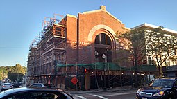 The substation being renovated in 2016. The new apartment building is at right. Roslindale substation with scaffolding, September 2016.jpg