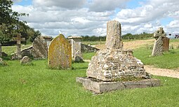 Base and broken shaft of a 15th-century preaching cross (right) in St Mary's churchyard