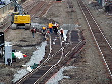 Track work near the station site in November 2015 Track workers for Boston Landing, November 2015.JPG